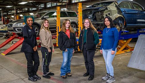 Five female students in the automotive lab